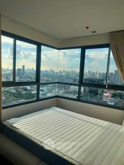 Stunning corner bedroom with panoramic city views and large windows.
