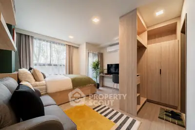 Modern studio apartment with cozy living area and stylish decor