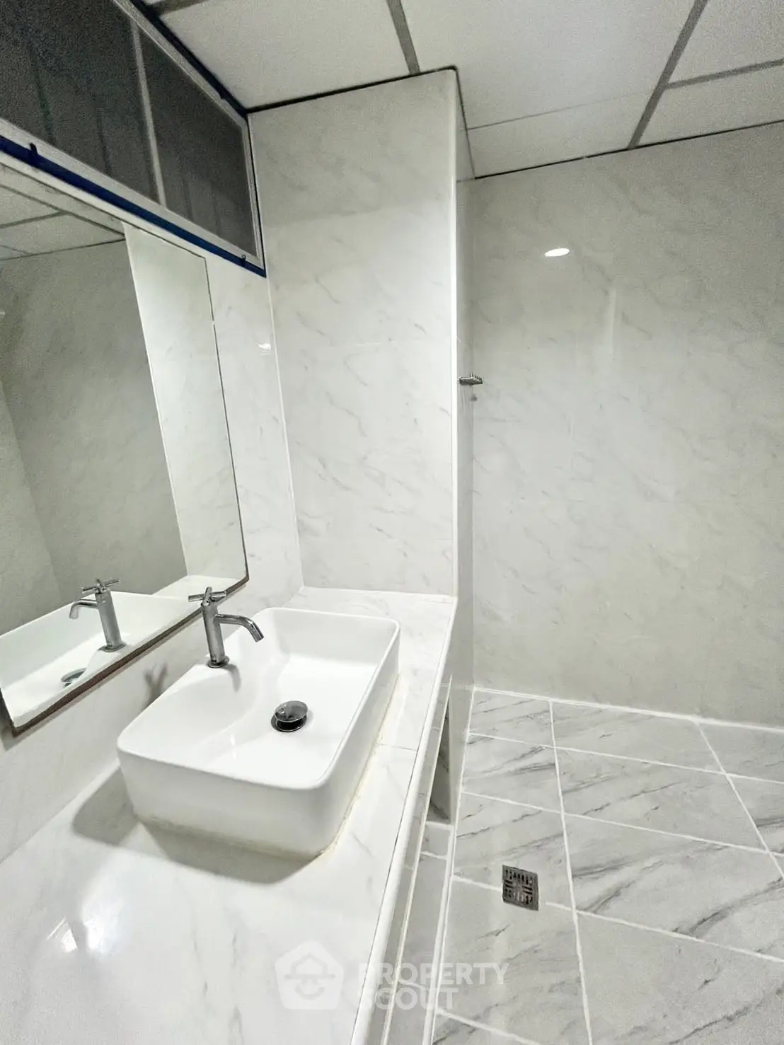 Modern bathroom with sleek white marble tiles and stylish sink