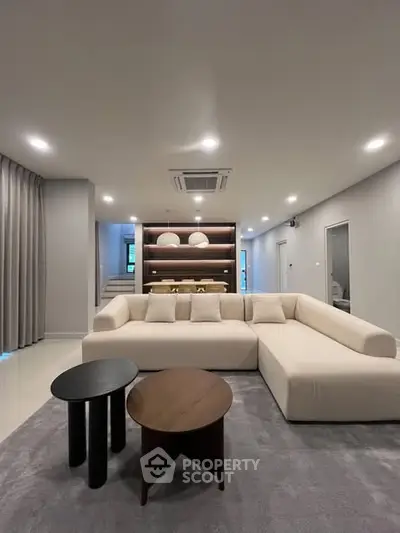 Modern living room with stylish furniture and elegant lighting, perfect for relaxation and entertainment.
