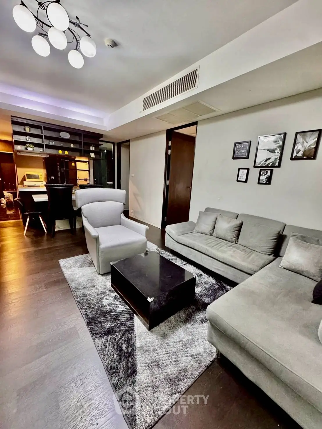 Modern living room with stylish furniture and open kitchen layout