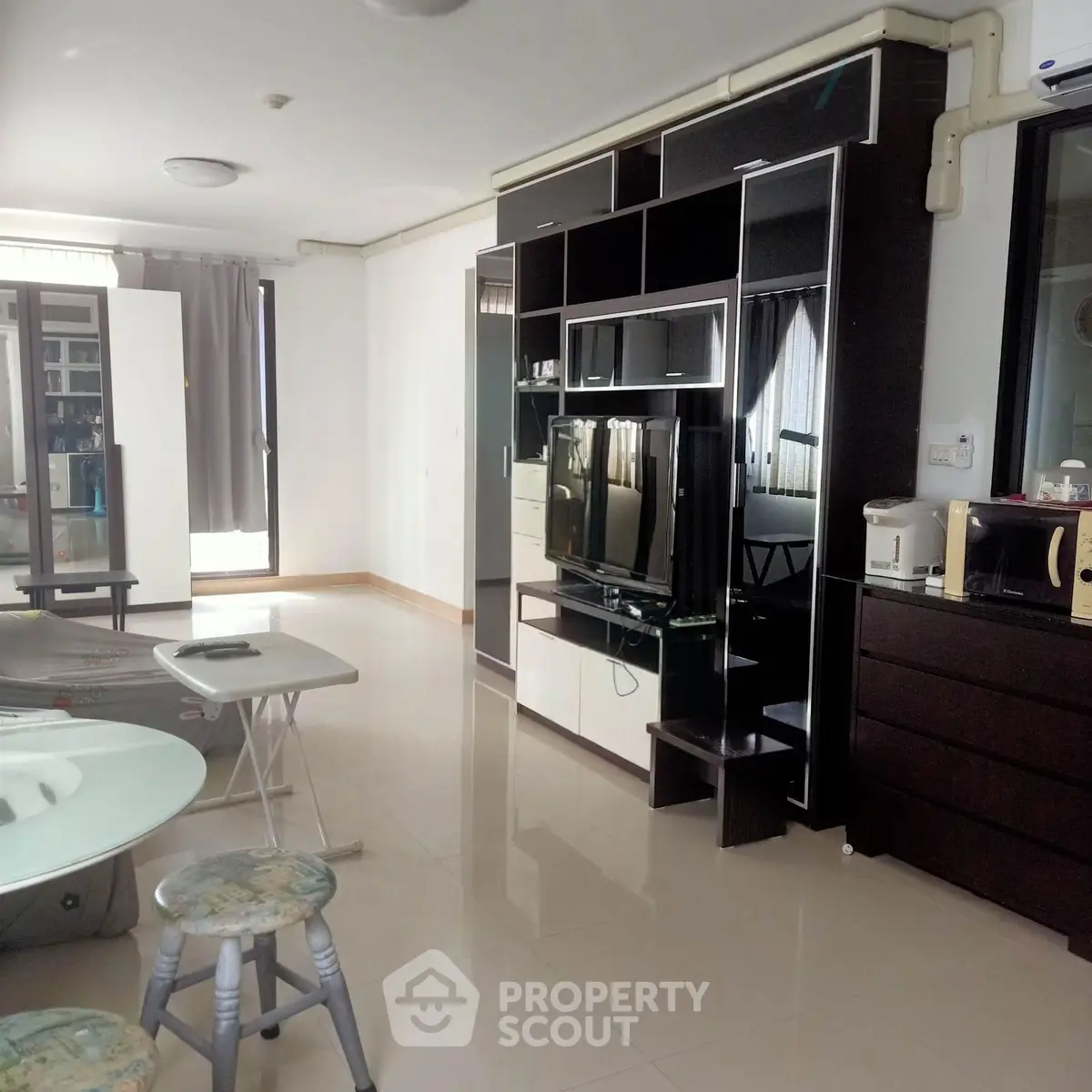 Spacious modern living room with sleek entertainment center and natural light