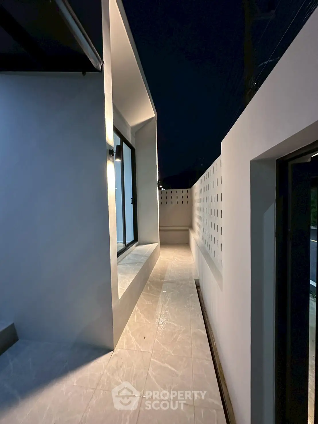 Modern exterior corridor with sleek design and ambient lighting