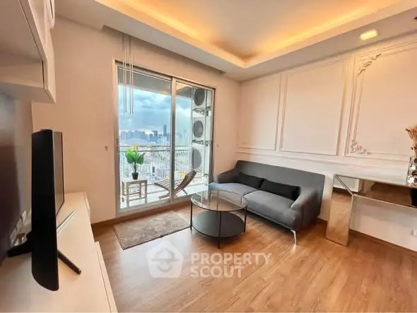 Modern living room with balcony and city view, featuring sleek furniture and elegant decor.