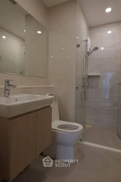 Modern bathroom with sleek fixtures and glass shower enclosure
