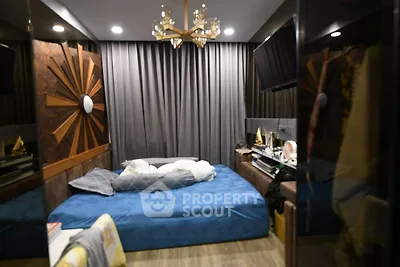 Luxurious bedroom with modern decor and elegant lighting, featuring a cozy bed and stylish furnishings.