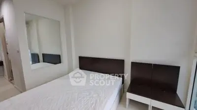 Modern minimalist bedroom with white walls and simple furnishings