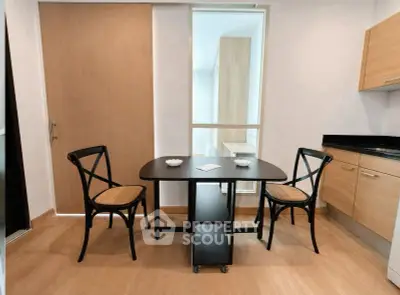 Modern kitchen with sleek wooden cabinets and stylish dining area