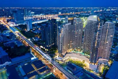 Stunning aerial view of modern high-rise buildings in a vibrant cityscape at night.