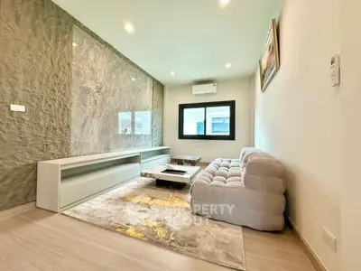 Modern living room with stylish decor and plush sofa in a contemporary apartment.