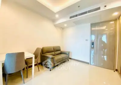 Modern living room with sleek furniture and bright lighting in a contemporary apartment.