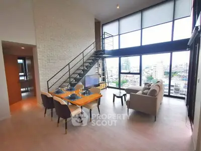 Stunning loft-style living room with floor-to-ceiling windows and city view