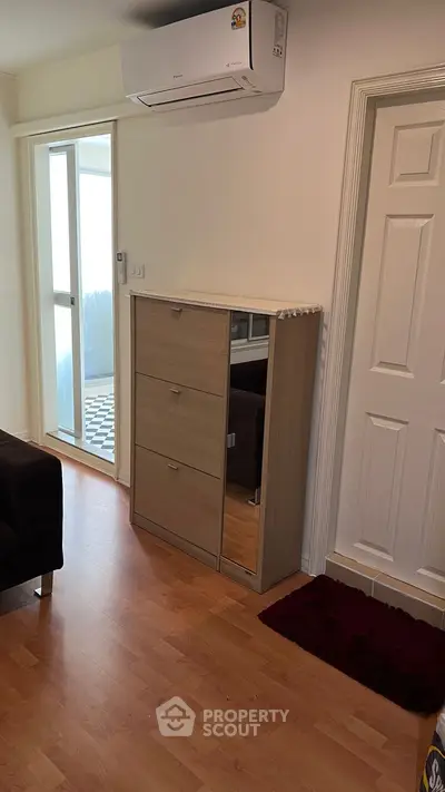 Modern living room with wooden flooring and air conditioning unit