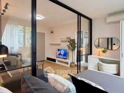 Modern living room with glass partition, stylish decor, and cozy ambiance