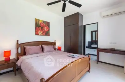 Spacious bedroom with elegant wooden furniture and modern decor in a stylish home.