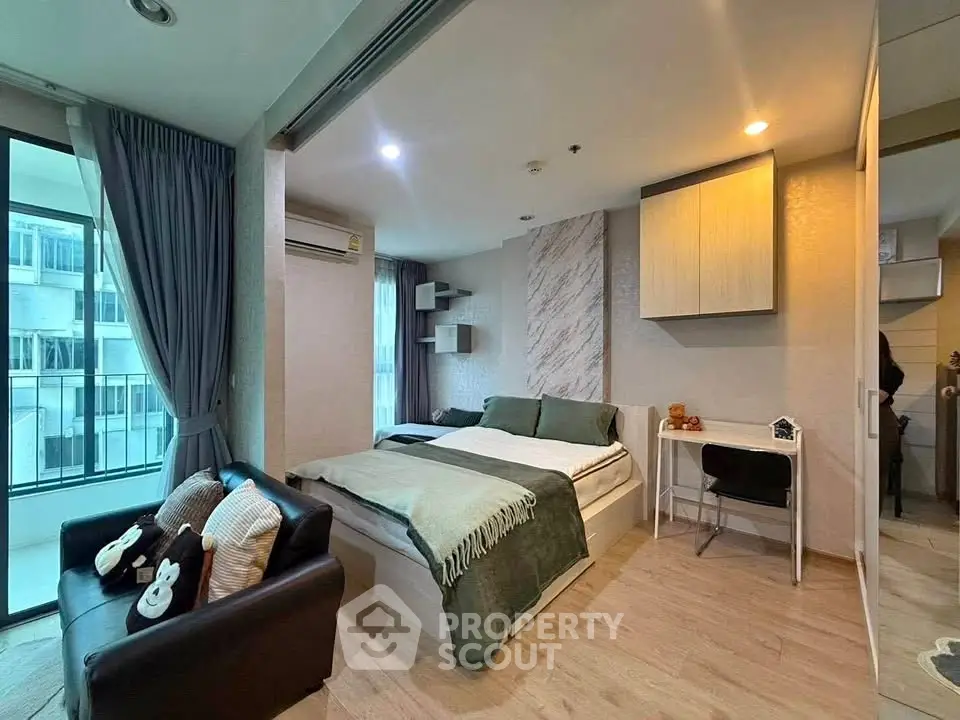 Modern bedroom with cozy decor and large windows in a stylish apartment.