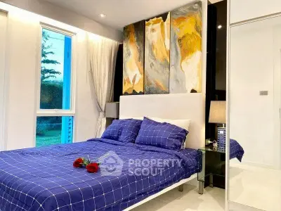 Elegant bedroom with modern art and cozy blue bedding