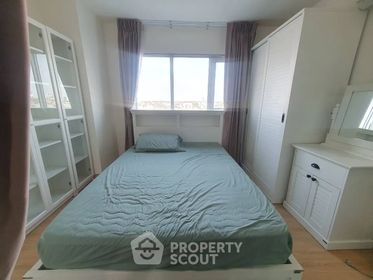 Cozy bedroom with large window and ample storage space