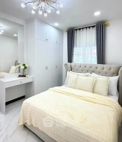 Luxurious bedroom with elegant decor and plush bedding in modern apartment.