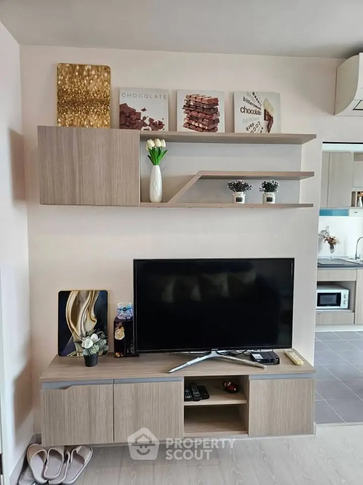 Modern living room with stylish TV unit and decorative shelves, perfect for cozy home entertainment.