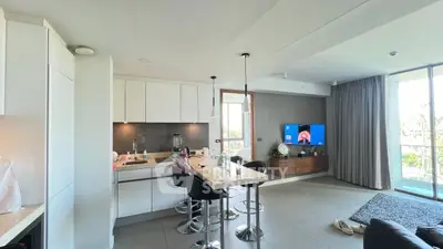 Modern open-plan kitchen and living room with sleek design and natural light.
