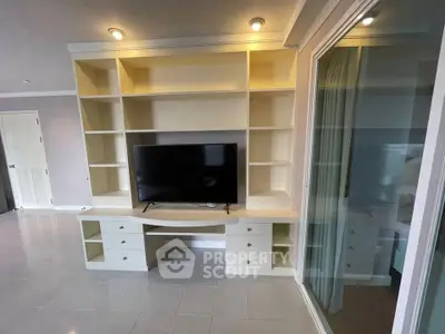 Spacious living room with built-in TV unit and modern design