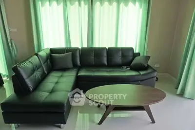 Modern living room with stylish black leather sofa and elegant coffee table