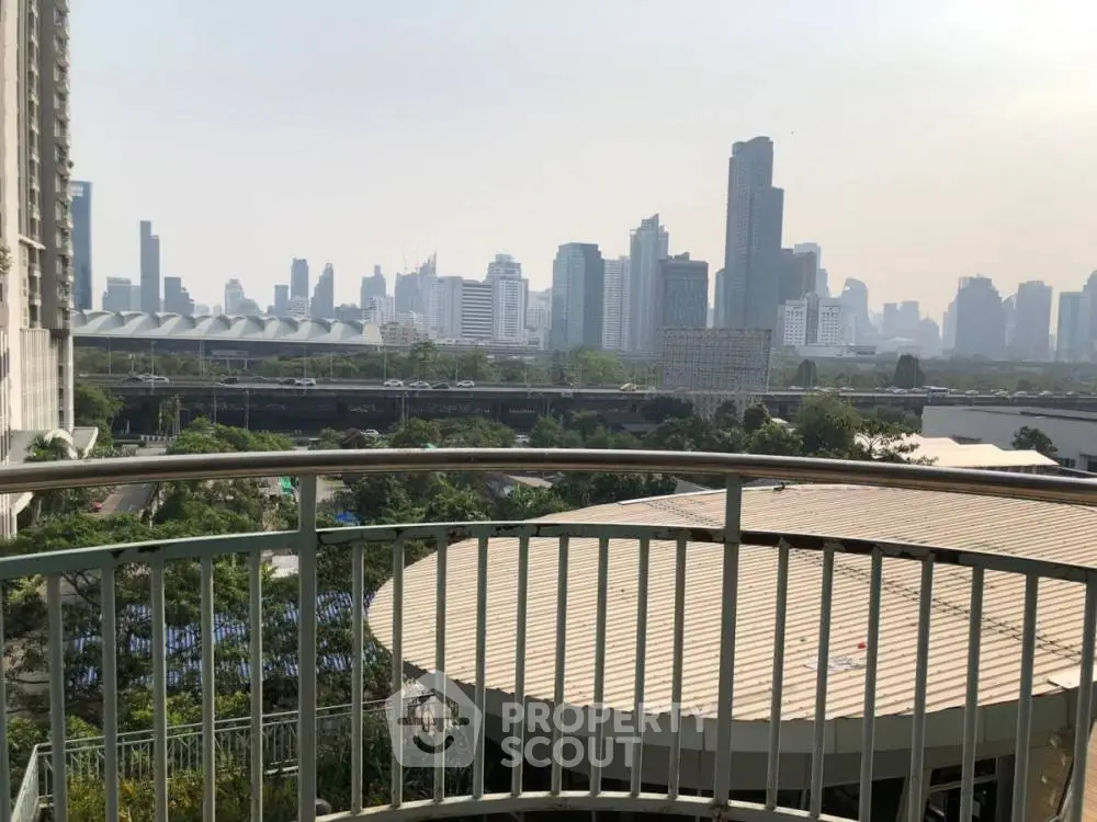 Stunning cityscape view from a spacious balcony overlooking urban skyline.