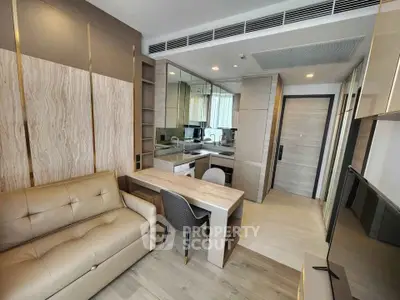 Modern living room with stylish furniture and open kitchen layout in a contemporary apartment.