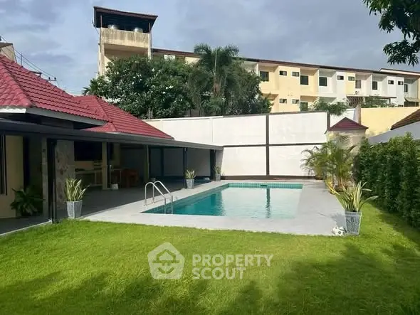 Luxurious backyard with private pool and lush garden in modern villa