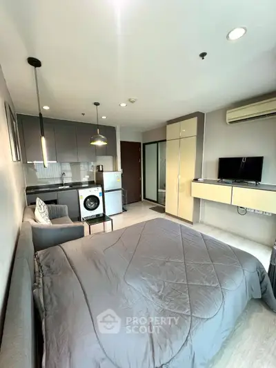 Modern studio apartment with sleek kitchen and cozy living area