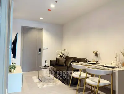 Modern living room with elegant decor and dining area, featuring a sleek sofa and stylish chairs.