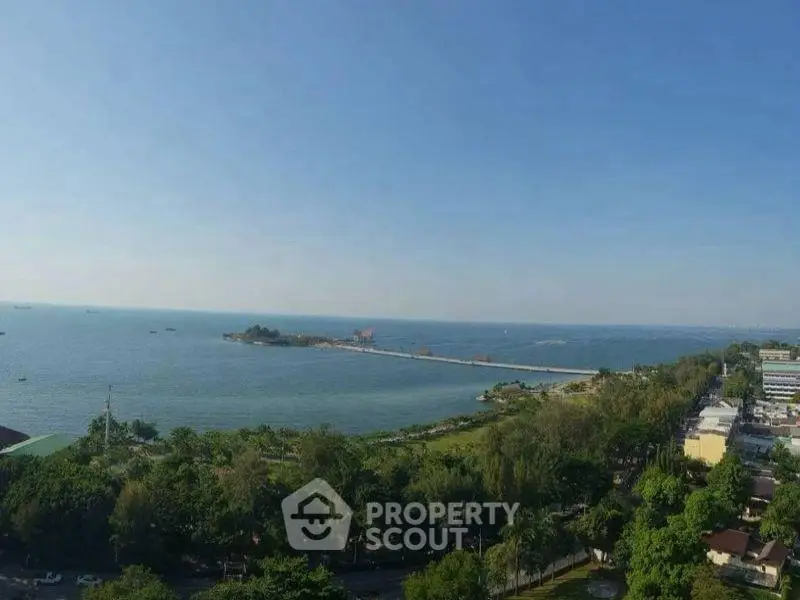Stunning ocean view from a high vantage point, showcasing lush greenery and serene waters.