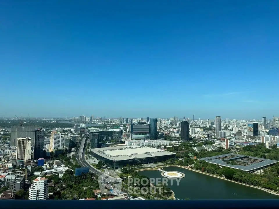 Stunning cityscape view from high-rise building showcasing urban skyline and lush greenery.