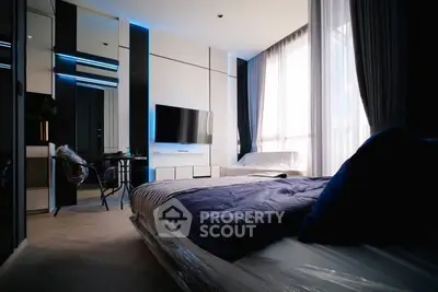 Modern bedroom with sleek design and large windows for natural light.