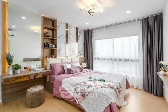 Luxurious bedroom with elegant decor and large window offering natural light.