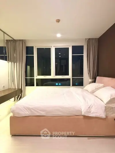 Spacious modern bedroom with large windows and elegant decor