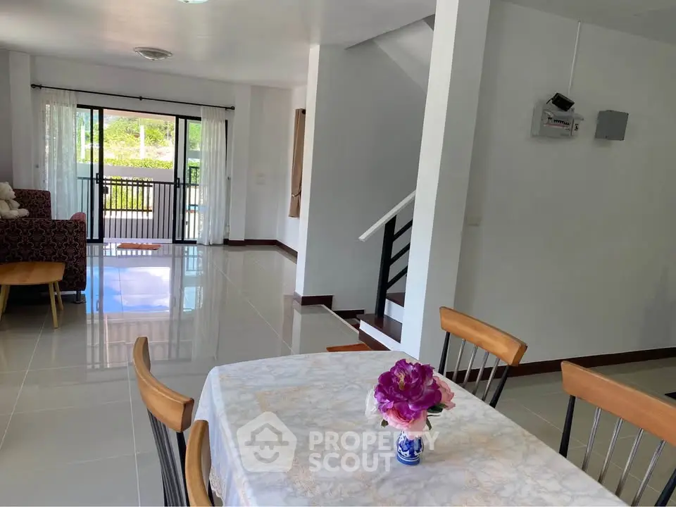 Spacious open-plan living and dining area with modern decor and natural light.