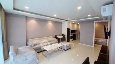 Spacious modern living room with elegant furniture and open kitchen layout in a luxury apartment.