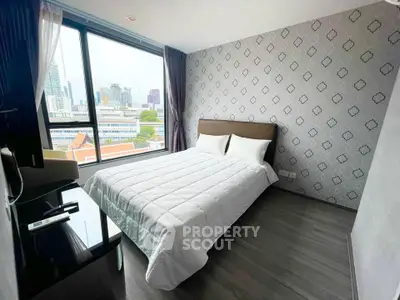 Modern bedroom with city view, featuring stylish wallpaper and cozy bedding in a high-rise apartment.