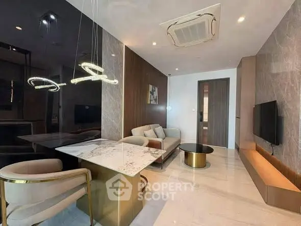 Luxurious modern living room with elegant marble dining table and stylish lighting fixtures.