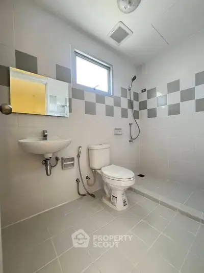 Modern bathroom with sleek white tiles and minimalist fixtures