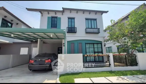 Charming two-story house with carport and lush garden in serene neighborhood.