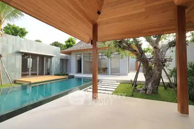 Luxurious modern villa with private pool and lush garden, perfect for relaxation and entertaining.