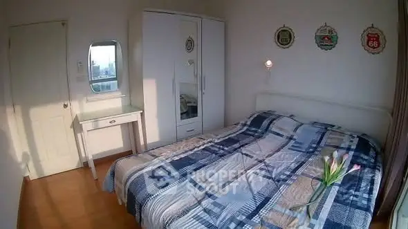 Cozy bedroom with stylish decor and ample natural light