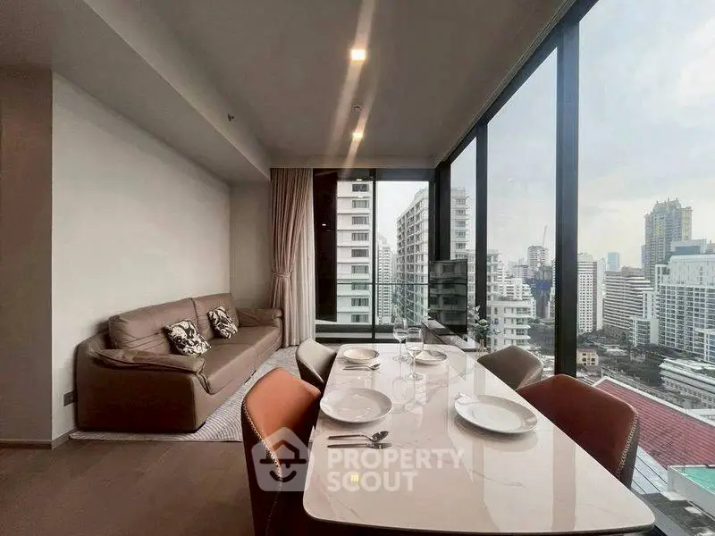 Modern living room with dining area and city view through large windows.