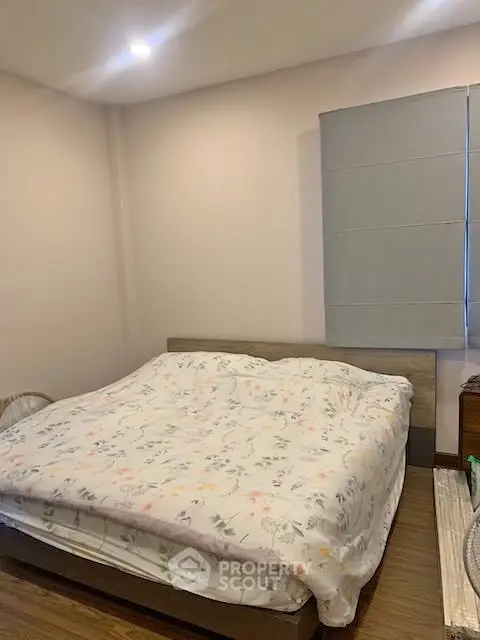 Cozy bedroom with floral bedding and modern decor