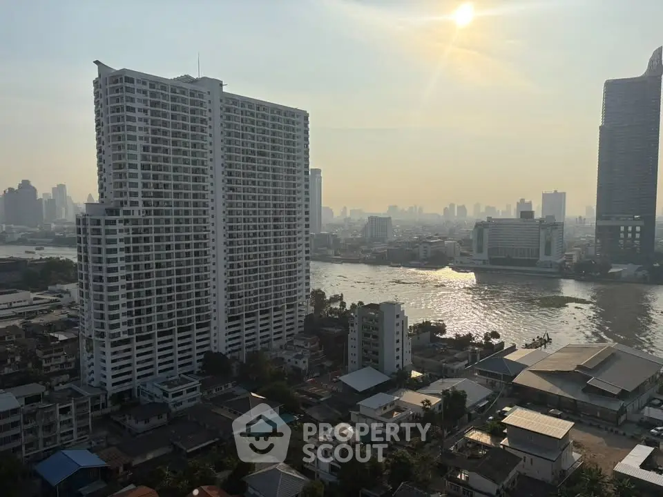 Stunning cityscape view with high-rise buildings and river at sunset, perfect for urban living enthusiasts.