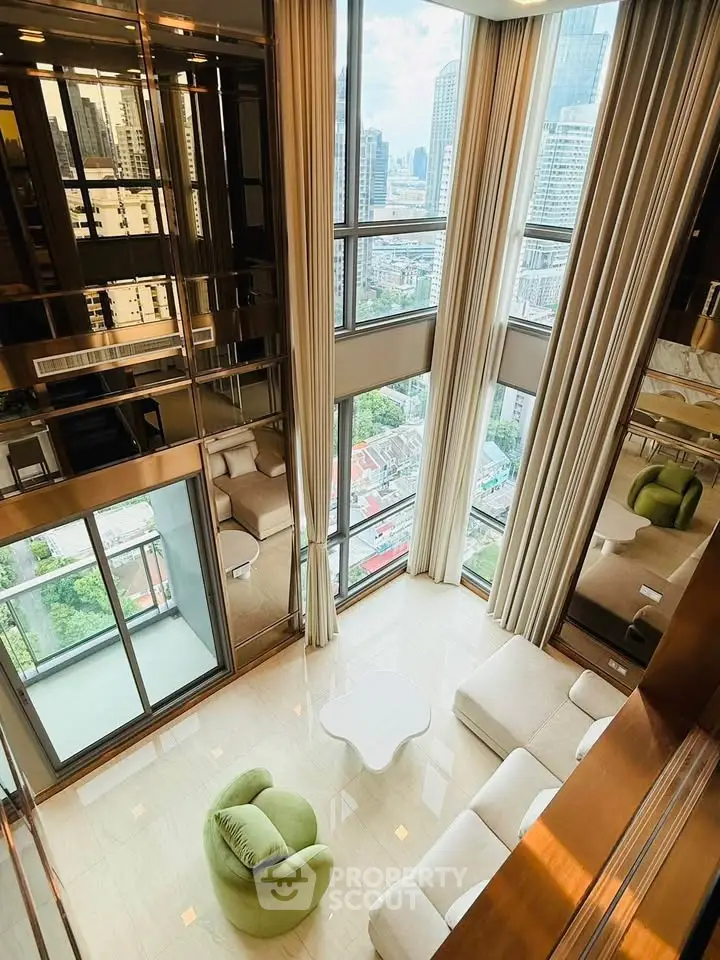 Luxurious high-rise living room with floor-to-ceiling windows and stunning city views.