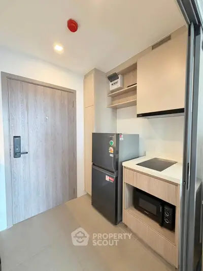 Modern compact kitchen with sleek appliances and minimalist design